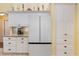Kitchen with white refrigerator, custom cabinets, granite counters, and a modern coffee maker at 25236 Waterbridge Ct, Leesburg, FL 34748