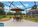 Covered patio with comfortable seating is the perfect place to relax and enjoy the outdoors at 25236 Waterbridge Ct, Leesburg, FL 34748