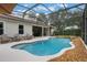 Beautiful, kidney-shaped pool features a waterfall and a screened enclosure for year-round enjoyment at 25236 Waterbridge Ct, Leesburg, FL 34748