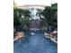 Beautiful backyard water feature with lush landscaping, rock features and home in background at 25236 Waterbridge Ct, Leesburg, FL 34748