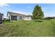 Well-maintained backyard featuring lush green grass, mature trees, and privacy at 2666 Meadowedge Loop, St Cloud, FL 34772
