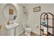 Powder bath featuring pedestal sink, decorative shelves, and framed artwork at 2666 Meadowedge Loop, St Cloud, FL 34772