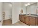 Elegant bathroom with granite countertops, wood cabinets, and a separate toilet area at 2666 Meadowedge Loop, St Cloud, FL 34772