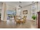 Bright dining room features an elegant glass table, decorative chairs, and sliding glass doors to the patio at 2666 Meadowedge Loop, St Cloud, FL 34772