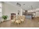 Dining room showcasing decorative chairs and access to the modern kitchen with gray cabinets at 2666 Meadowedge Loop, St Cloud, FL 34772