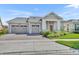 Charming single-story home featuring a three-car garage, well-manicured lawn, and inviting entryway at 2666 Meadowedge Loop, St Cloud, FL 34772