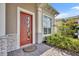 Inviting front entrance featuring a brick walkway, colorful plants, and a stylish door with decorative accents at 2666 Meadowedge Loop, St Cloud, FL 34772