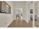 Clean hallway featuring neutral colored walls, tile flooring, and access to the rest of the home at 2666 Meadowedge Loop, St Cloud, FL 34772