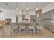 Stylish kitchen island with barstool seating, pendant lighting, and modern gray cabinetry at 2666 Meadowedge Loop, St Cloud, FL 34772