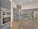 Updated kitchen with stainless steel appliances, granite counters, and tiled backsplash at 2666 Meadowedge Loop, St Cloud, FL 34772