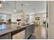 Modern kitchen with stainless steel appliances, granite countertops, and a large central island overlooking living spaces at 2666 Meadowedge Loop, St Cloud, FL 34772
