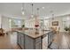 Bright open kitchen with a central island, stainless steel dishwasher, and ample counter space for cooking at 2666 Meadowedge Loop, St Cloud, FL 34772