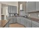 Gourmet kitchen with stainless appliances, stylish cabinetry, granite countertops, and tiled backsplash at 2666 Meadowedge Loop, St Cloud, FL 34772