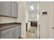 Well-lit laundry room with gray cabinets, granite countertops, washer, and dryer at 2666 Meadowedge Loop, St Cloud, FL 34772
