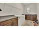 Functional laundry room with granite countertops, washer, dryer, and storage cabinets at 2666 Meadowedge Loop, St Cloud, FL 34772