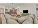 Bright living room boasts neutral colors, tile flooring, and open layout to the kitchen and dining area at 2666 Meadowedge Loop, St Cloud, FL 34772