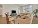 Well-lit living room features a comfortable couch, stylish rug, and large window with sheer curtains at 2666 Meadowedge Loop, St Cloud, FL 34772