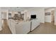 Bright open-concept living room and kitchen featuring an oversized sofa, pendant lights, and tile floors at 2666 Meadowedge Loop, St Cloud, FL 34772