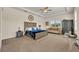 Comfortable main bedroom featuring a king-size bed, sitting area, and tray ceiling at 2666 Meadowedge Loop, St Cloud, FL 34772