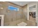 Large shower with glass enclosure, bench seating, and tiled walls, next to walk in closet at 2666 Meadowedge Loop, St Cloud, FL 34772