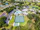Bird's eye view featuring community recreational facilities like the tennis court and pool area surrounded by trees and landscaping at 27018 Nature View St, Leesburg, FL 34748