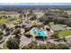 Aerial view of the community featuring a pool, tennis courts, and clubhouse at 27018 Nature View St, Leesburg, FL 34748