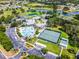 Aerial photograph revealing community facilities and amenities including pools and tennis courts nestled among greenery, showing leisure options at 27018 Nature View St, Leesburg, FL 34748