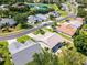 Peaceful neighborhood featuring well-maintained homes, a tranquil pond, and verdant landscaping at 27018 Nature View St, Leesburg, FL 34748