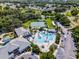 High-angle picture showcasing community's pool, tennis courts, clubhouse, and lush surroundings, highlighting leisure amenities at 27018 Nature View St, Leesburg, FL 34748
