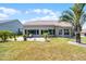 Well maintained backyard featuring a patio, tropical landscaping, and a healthy green lawn at 27018 Nature View St, Leesburg, FL 34748