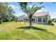 Lush backyard showcasing mature trees, manicured lawn, and a cozy patio area, perfect for outdoor enjoyment at 27018 Nature View St, Leesburg, FL 34748