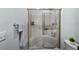 The bathroom includes a glass shower with a built-in bench and a convenient toilet location at 27018 Nature View St, Leesburg, FL 34748