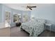 This bedroom features a ceiling fan, a bay window with white shutters, and carpeted flooring at 27018 Nature View St, Leesburg, FL 34748
