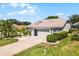 Charming home featuring a well-manicured lawn, lovely landscaping, and an attached two-car garage at 27018 Nature View St, Leesburg, FL 34748