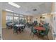 Game room with tables and chairs, bathed in natural light from large windows at 27018 Nature View St, Leesburg, FL 34748