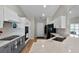 A well-lit kitchen featuring granite countertops, modern appliances, and white and gray cabinetry at 27018 Nature View St, Leesburg, FL 34748