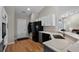 Bright kitchen showcasing stone countertops, stainless steel sink, and stylish white and gray cabinets at 27018 Nature View St, Leesburg, FL 34748