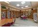 Cozy library with floor-to-ceiling bookshelves and tables for reading at 27018 Nature View St, Leesburg, FL 34748