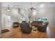 Bright living room featuring hardwood floors, vaulted ceilings, and modern furniture at 27018 Nature View St, Leesburg, FL 34748