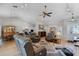 Bright living room featuring hardwood floors, vaulted ceilings, with views into dining area at 27018 Nature View St, Leesburg, FL 34748