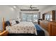 This spacious main bedroom features a ceiling fan, carpeted floor, and bay window with natural lighting at 27018 Nature View St, Leesburg, FL 34748