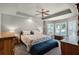This main bedroom features a ceiling fan, carpeted floor, and a bay window with white shutters at 27018 Nature View St, Leesburg, FL 34748