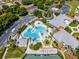 Aerial view of a beautiful community pool with palm trees, lounge chairs, and ample parking at 27018 Nature View St, Leesburg, FL 34748
