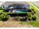 Aerial view showcases a pool, the screened-in lanai, and lush landscaping, offering privacy and beauty at 27146 Greenfly Orchid Ln, Leesburg, FL 34748