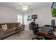 This bedroom has a comfortable couch, desk, and lots of space for relaxation at 27146 Greenfly Orchid Ln, Leesburg, FL 34748