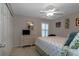 Bedroom features a bed, dresser, closet, and bright natural light at 27146 Greenfly Orchid Ln, Leesburg, FL 34748