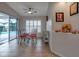 Breakfast nook features a ceiling fan, a table with chairs, and natural light at 27146 Greenfly Orchid Ln, Leesburg, FL 34748