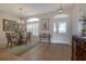 Dining room with elegant chandelier, neutral paint, wainscotting, and lots of natural light at 27146 Greenfly Orchid Ln, Leesburg, FL 34748