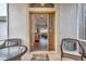 Inviting entryway featuring a beveled-glass door, seating, and views into the living area at 27146 Greenfly Orchid Ln, Leesburg, FL 34748