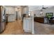 Bright kitchen featuring tile floors, white cabinetry, and an open layout to the living area at 27146 Greenfly Orchid Ln, Leesburg, FL 34748